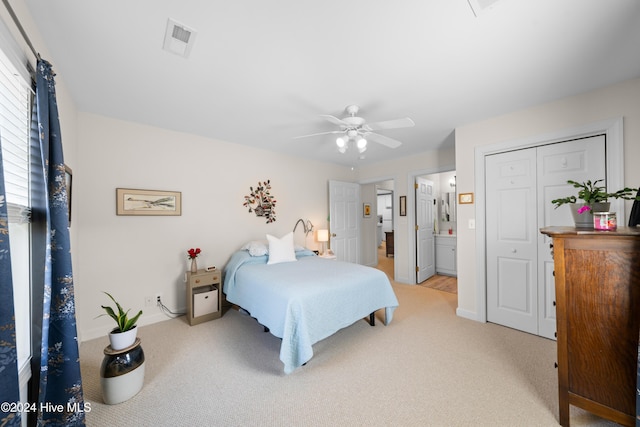 carpeted bedroom with ceiling fan, ensuite bathroom, and a closet