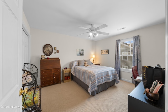 carpeted bedroom featuring ceiling fan and a closet