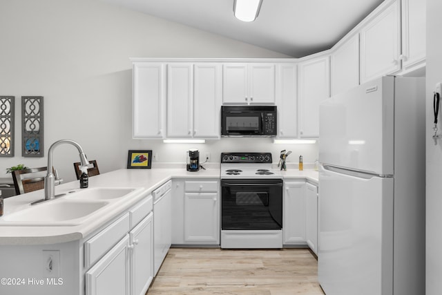 kitchen with kitchen peninsula, lofted ceiling, sink, and white appliances