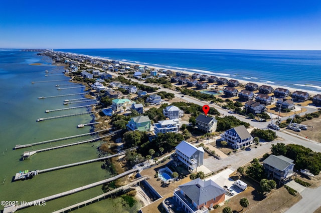 drone / aerial view with a water view and a beach view