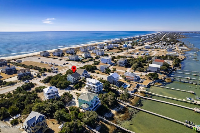 drone / aerial view with a beach view and a water view