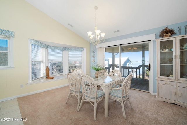 dining room featuring lofted ceiling, light tile patterned floors, and a chandelier