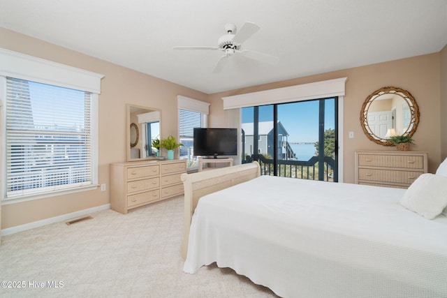 bedroom with access to outside, light colored carpet, and ceiling fan