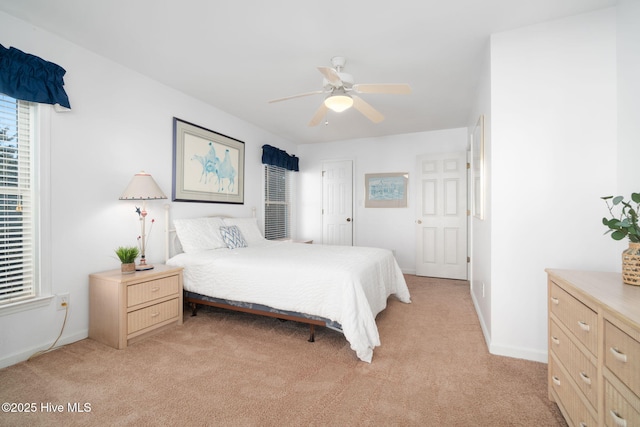 bedroom featuring ceiling fan and light carpet