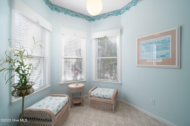 sitting room featuring light colored carpet