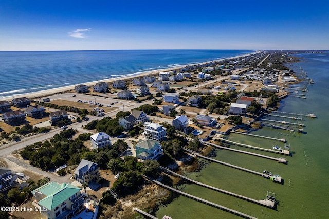 drone / aerial view featuring a water view and a beach view