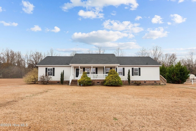 ranch-style home with covered porch and a front lawn