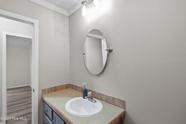 bathroom featuring vanity and ornamental molding