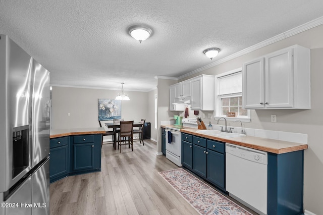 kitchen featuring wood counters, white cabinetry, white appliances, and hanging light fixtures