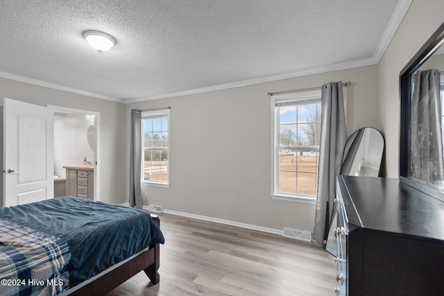 bedroom featuring multiple windows, crown molding, light hardwood / wood-style flooring, and a textured ceiling