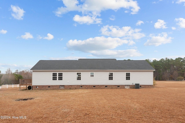 back of property featuring central AC