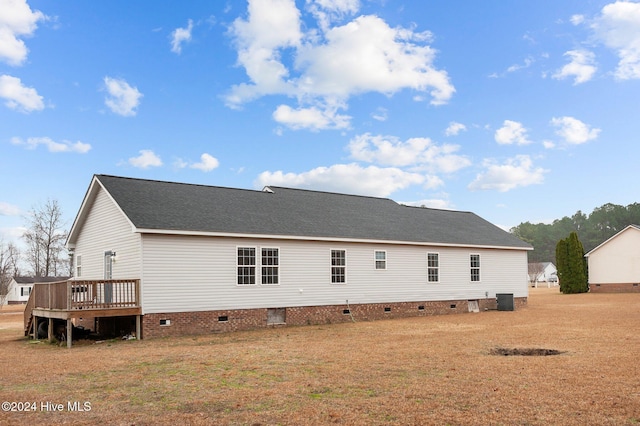 rear view of house featuring a wooden deck and cooling unit