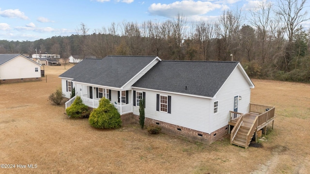 view of front of property featuring a front lawn and a wooden deck