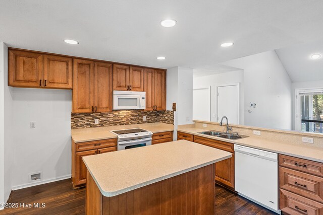 kitchen with white appliances, dark hardwood / wood-style flooring, sink, and backsplash