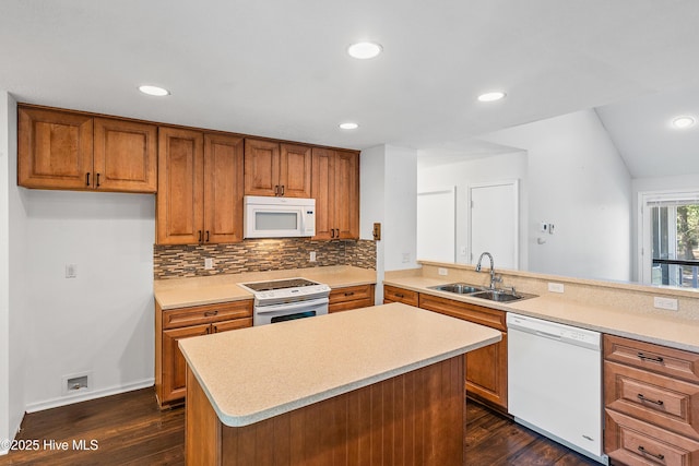 kitchen with light countertops, white appliances, dark wood-style flooring, and a sink