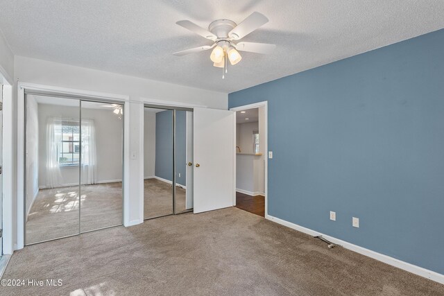 bathroom featuring vanity, a textured ceiling, and a shower with shower door