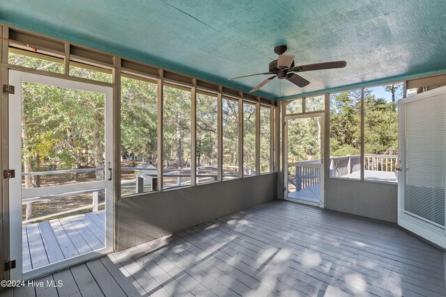 unfurnished bedroom with multiple closets, ceiling fan, carpet floors, and a textured ceiling