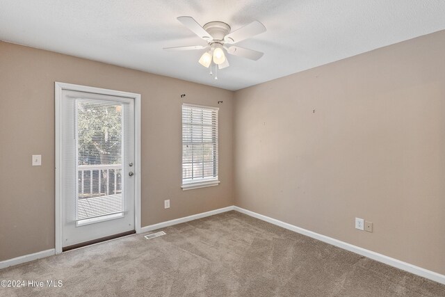 unfurnished bedroom featuring ceiling fan, carpet flooring, and a closet