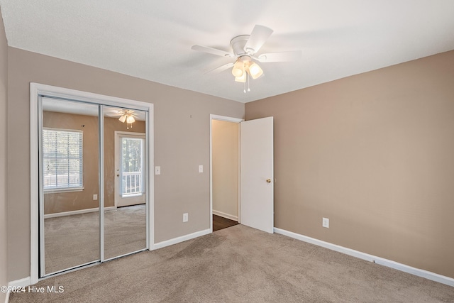 unfurnished bedroom featuring carpet floors, a ceiling fan, baseboards, and a closet