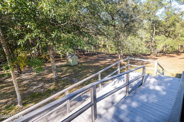 wooden deck with an outdoor structure and a shed