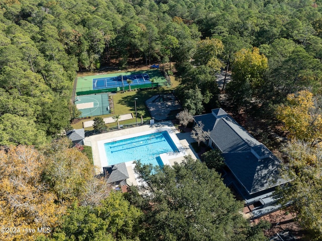 birds eye view of property featuring a view of trees