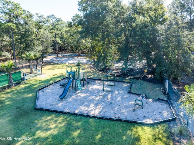 surrounding community featuring playground community, a yard, and fence