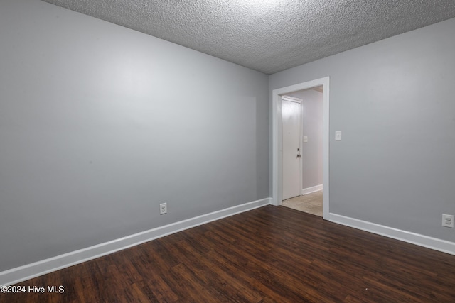 empty room featuring hardwood / wood-style flooring and a textured ceiling