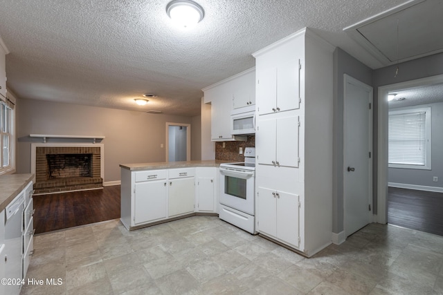 kitchen featuring kitchen peninsula, white cabinetry, white appliances, and decorative backsplash