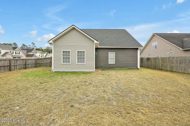 rear view of property with a lawn