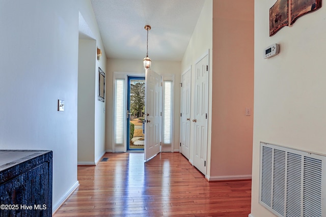 entryway with hardwood / wood-style floors