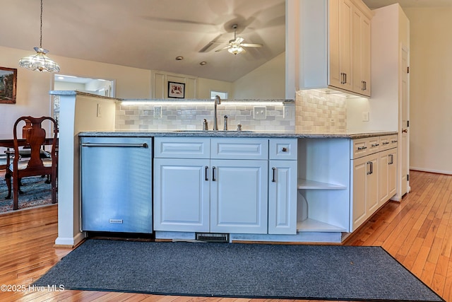 kitchen featuring decorative light fixtures, white cabinetry, dishwasher, sink, and light hardwood / wood-style floors