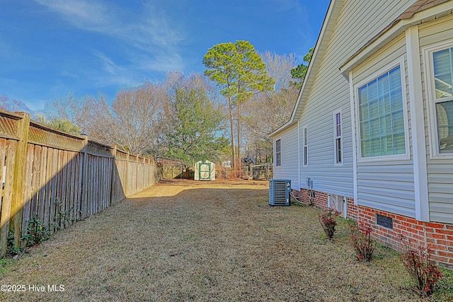 view of yard featuring central AC and a storage shed