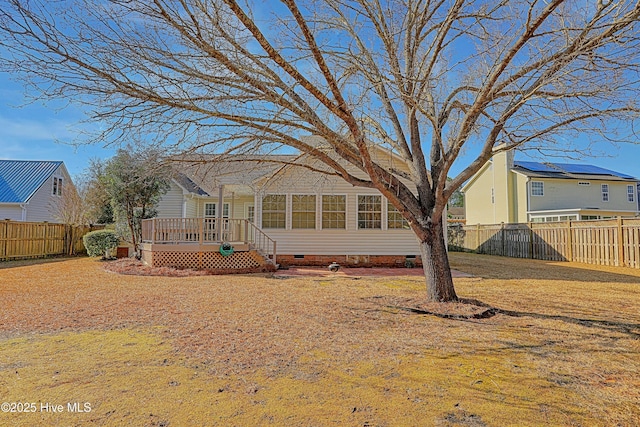 view of front of property featuring a wooden deck and a front lawn