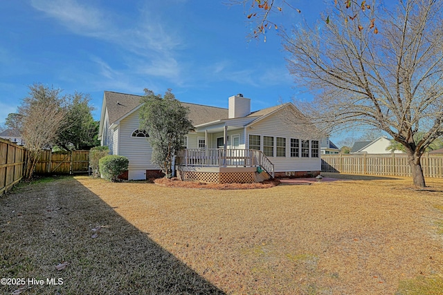 back of house with a yard and a deck