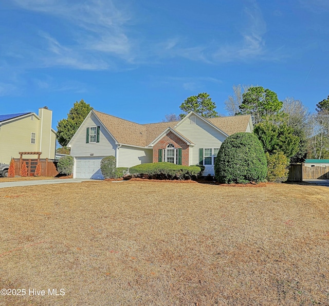 view of front of home featuring a garage and a front lawn