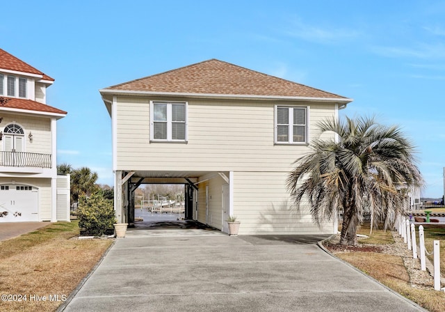 view of front of house with a garage and a carport