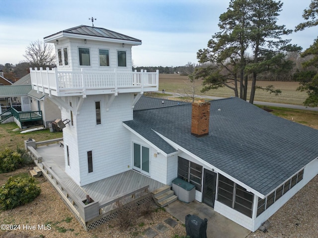 back of house featuring a balcony