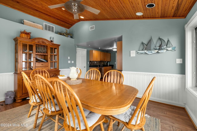 dining area with light hardwood / wood-style floors, wooden ceiling, and lofted ceiling