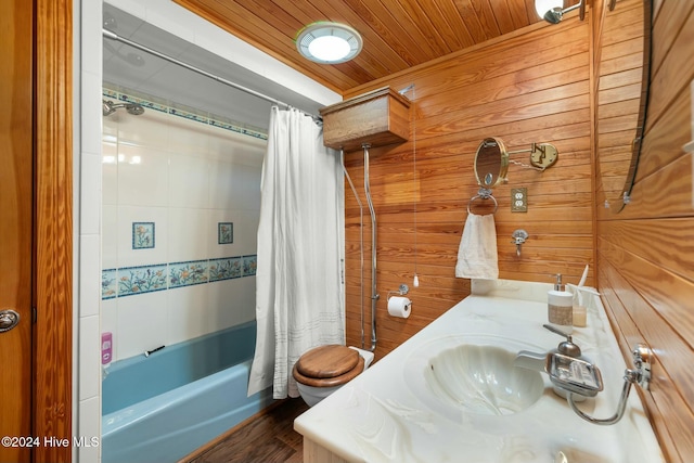 full bathroom featuring wood ceiling, shower / tub combo, wood walls, toilet, and vanity