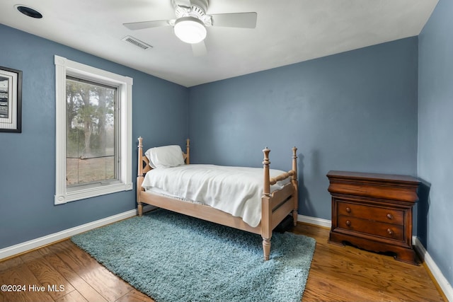 bedroom with ceiling fan and hardwood / wood-style flooring