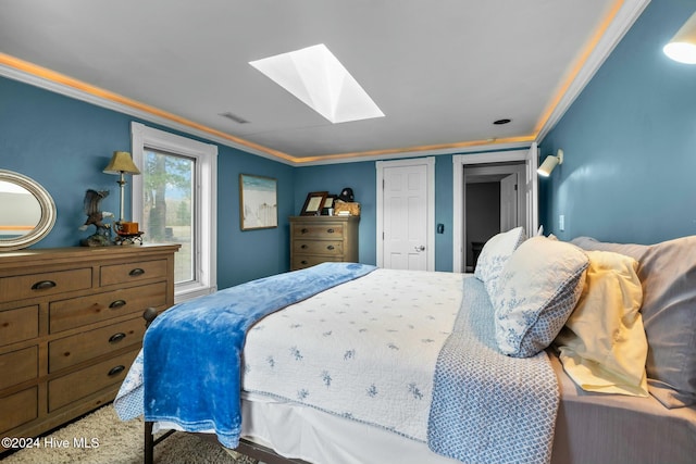 bedroom featuring a skylight and crown molding