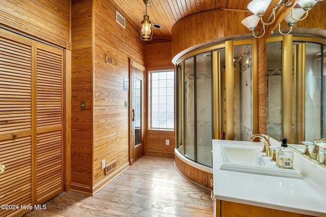 bathroom with vanity, wood walls, vaulted ceiling, and wood ceiling