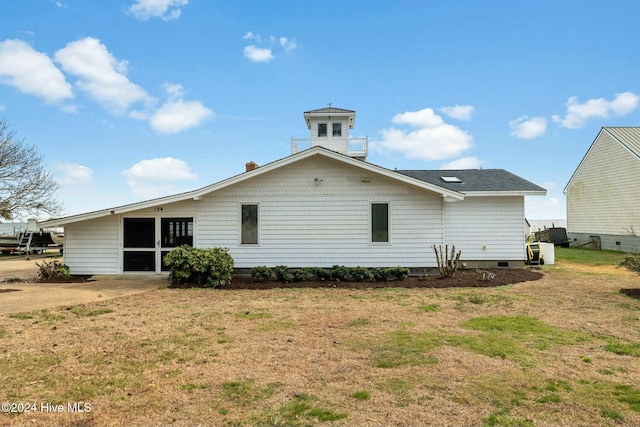 back of house with a lawn