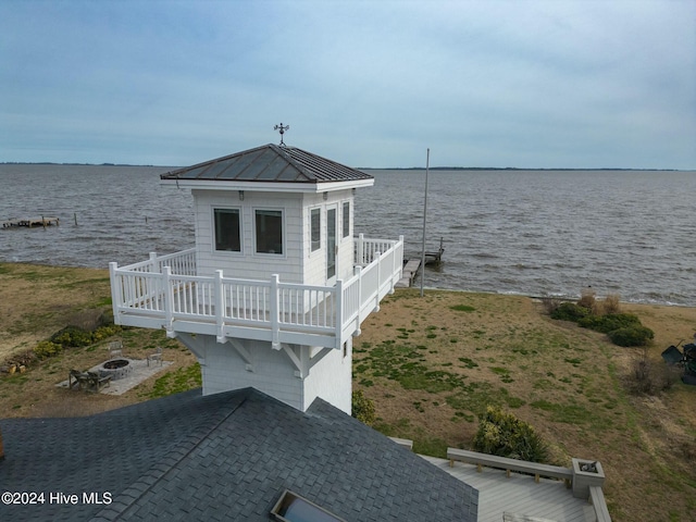 view of dock featuring a fire pit and a water view