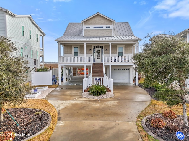 beach home featuring covered porch and a garage