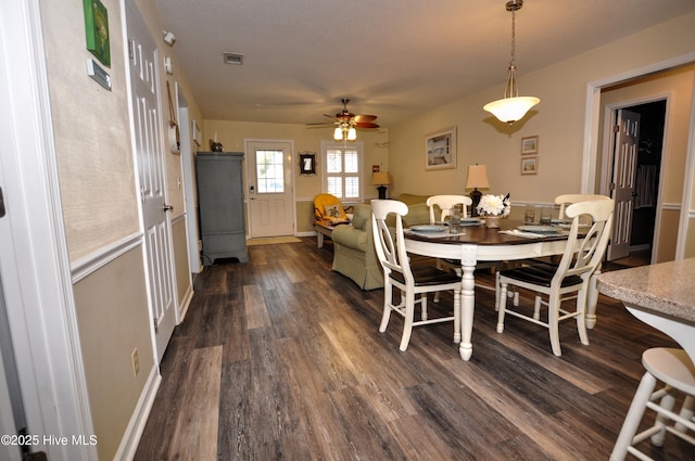 dining room with dark wood-type flooring and ceiling fan