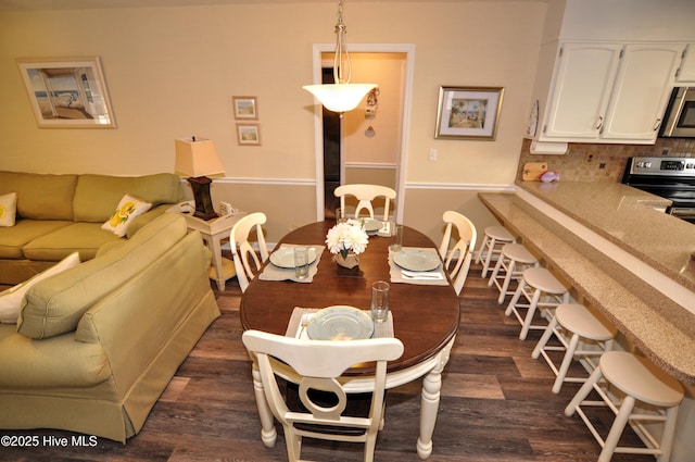 dining area with dark wood-type flooring