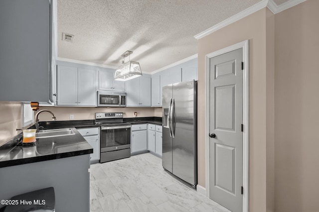 kitchen featuring gray cabinetry, sink, hanging light fixtures, stainless steel appliances, and ornamental molding