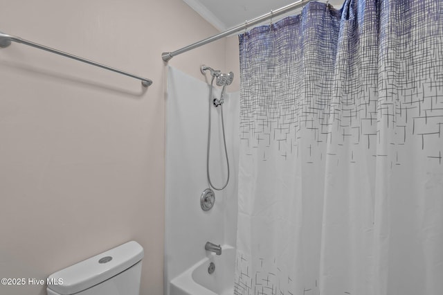 bathroom featuring crown molding, shower / tub combo with curtain, and toilet