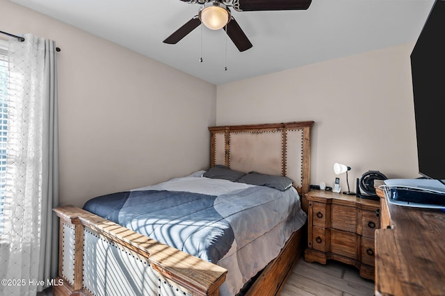 bedroom featuring light hardwood / wood-style flooring and ceiling fan